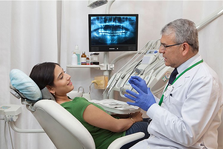 A dentist explaining treatment to a patient